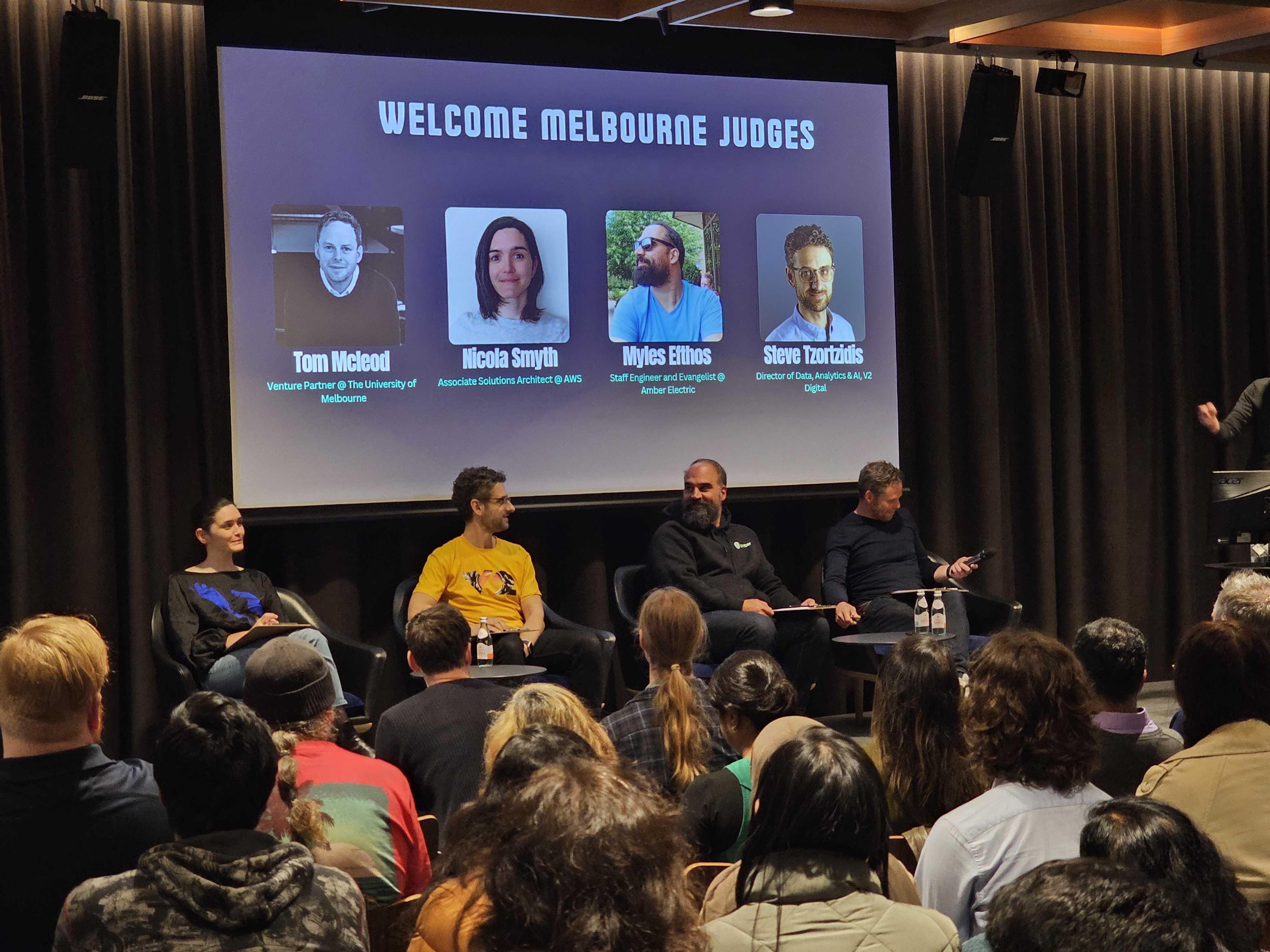 Image of V2 AI Director Steve Tzortzidis at an AI meetup judging on a panel